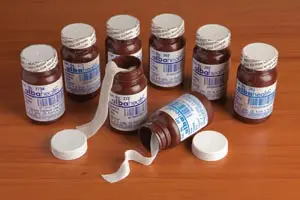 A group of bottles of medicine on a table.