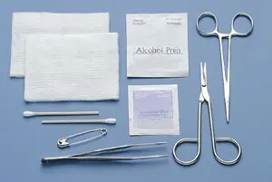 A surgical kit with scissors, bandages, and other items.