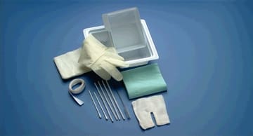 A surgical kit with a knife, scissors, and other items.