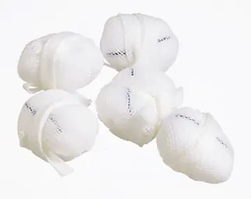 Four white plastic balls on a white surface.