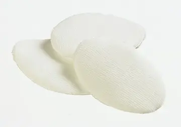 Three pieces of white cloth on a white surface.