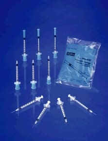 Syringes, needles and syringes on a blue background.