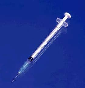 A syringe on a blue background.