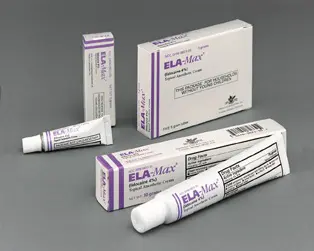 Four tubes of elamax on a grey surface.