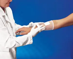 A woman in a lab coat is holding a patient's arm.