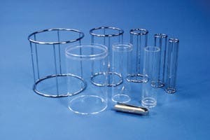 A group of clear glass tubes and a metal tube.