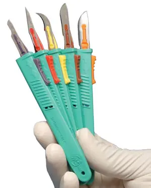 A person holding a pair of scissors with different colored blades.