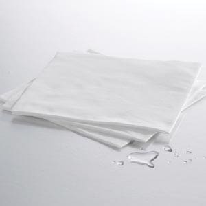 A stack of white napkins on a white surface.