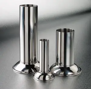 Three stainless steel vases on a table.