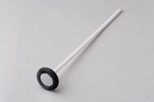 A black and white plastic spoon on a white surface.