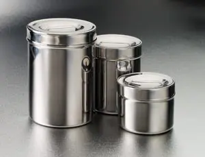 Three stainless steel canisters on a table.