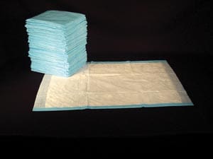 A stack of blue cloth diapers on a black background.