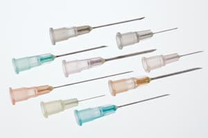 A group of plastic needles on a white background.