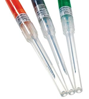 Three different colored syringes on a white background.