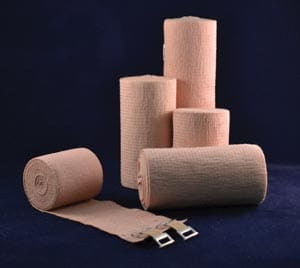 Four rolls of bandages on a blue background.