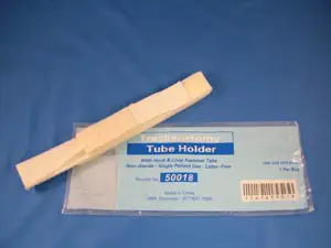 A tube holder and its packaging on the table.