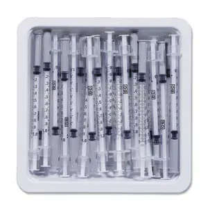 A box of syringes in a white tray.