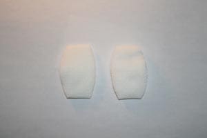 A pair of white socks on a white surface.