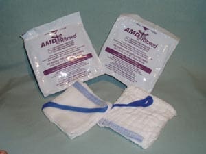 A pair of towels with a blue ribbon on them.