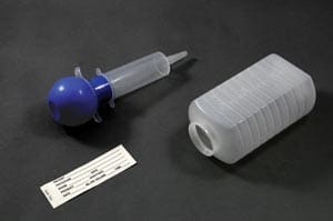 A plastic syringe with a label on it.