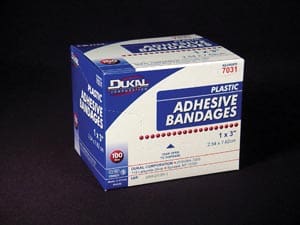 A box of adhesive bandages on a black background.