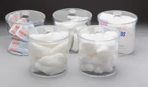 Four clear jars filled with cotton balls, bandages, and bandages.