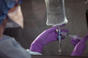 A surgeon injecting a patient with a syringe.