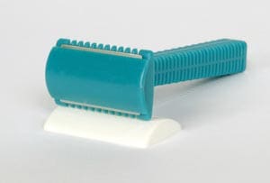 A blue and white shaving razor on a white surface.