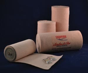 Four rolls of tan bandages on a blue background.