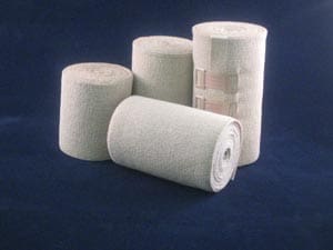 Four rolls of bandages on a blue background.