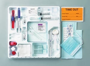 A medical kit with a mask, gloves, and syringes.