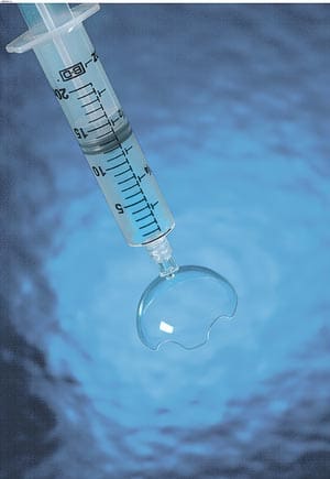 A syringe being injected into a body of water.