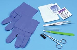 A medical kit with gloves, scissors and a pair of gloves.