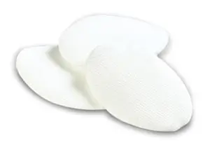 Three white cloth pads on a white surface.