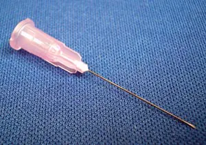 A pink needle on a blue surface.