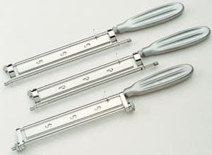 Three stainless steel cutters on a white surface.