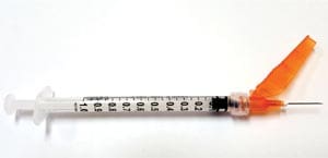 A syringe with an orange syringe.