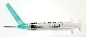 A syringe with a green syringe attached to it.