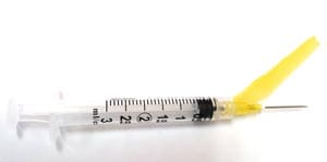 A syringe with a yellow syringe.