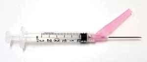 A syringe with a pink needle on it.