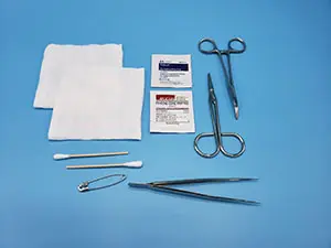 A medical kit with scissors and other items on a blue background.