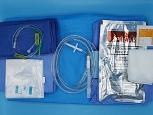 A medical kit with various items on a blue background.