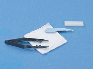 A pair of scissors and a piece of cloth on a blue background.