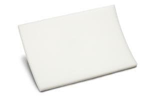 A white foam pad on a white surface.