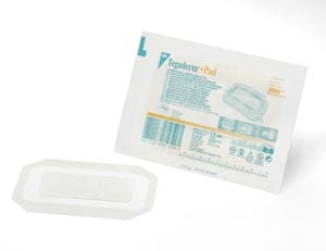 A package of sterile dressings on a white surface.