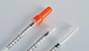 A syringe with a needle and a syringe.