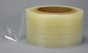 A roll of clear plastic tape on a grey background.