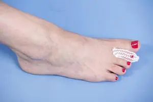 A woman's foot with a white bandage on it.