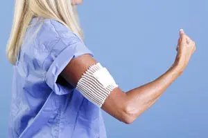 A woman with a bandage on her arm.