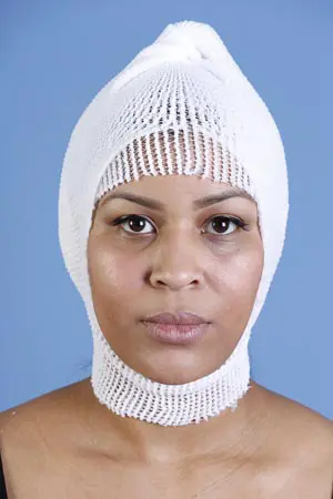 A woman wearing a white hat on her head.